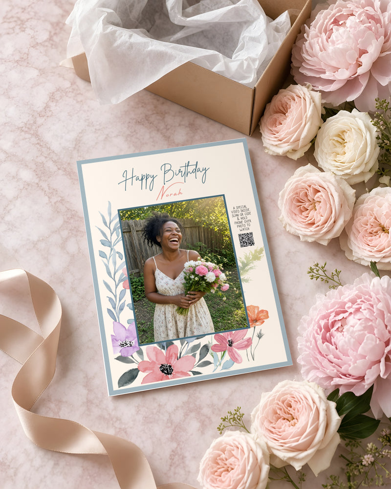 The Birthday Floral Card with a birthday photo, on pink marble with peonies and a gift box