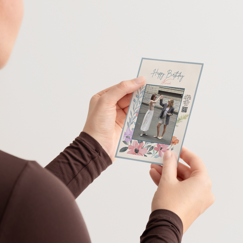 Floral birthday video greeting card held in hands